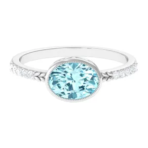 Bezel Set Oval Aquamarine East West Engagement Ring with Diamond
